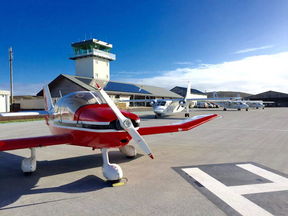 Robin DR400, G-GAOH, in front of Land's End Air Traffic Control Tower, with an Isles of Scilly Skybus Twin Otter aircraft behind